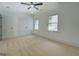 Bright bedroom with carpet, featuring a ceiling fan, and windows offering natural light and a view at 5106 N Pratt St, Covington, GA 30014
