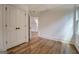 Bedroom featuring wood-look floors, double doors, and a well-lit interior at 5106 N Pratt St, Covington, GA 30014