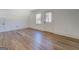 Bonus room featuring light wood floors, white walls, and natural light from the door and window at 5106 N Pratt St, Covington, GA 30014