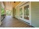 Long covered porch with white beams and wood ceiling at 5106 N Pratt St, Covington, GA 30014
