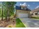 Exterior view of the garage showcasing the siding, windows, and landscaping at 5106 N Pratt St, Covington, GA 30014