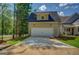 Exterior view of the garage showcasing the siding, windows, driveway, and landscaping at 5106 N Pratt St, Covington, GA 30014