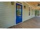 Front exterior view of porch with blue door, wood ceiling, and lights at 5106 N Pratt St, Covington, GA 30014