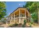 Angle view of house exterior with porch, wood ceiling, and landscaping at 5106 N Pratt St, Covington, GA 30014