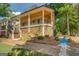 House exterior with covered porch, wood ceiling, and stone landscaping at 5106 N Pratt St, Covington, GA 30014