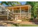 Inviting front porch with wood ceiling, fan, railing, and stairs at 5106 N Pratt St, Covington, GA 30014
