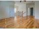 Bright hallway featuring hardwood floors, white walls and staircase with black railings at 5106 N Pratt St, Covington, GA 30014