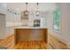 Modern kitchen with white cabinets, stainless steel appliances, and a central island at 5106 N Pratt St, Covington, GA 30014