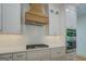 Beautiful kitchen features white subway tile backsplash, gas range, and built-in double ovens at 5106 N Pratt St, Covington, GA 30014