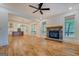 Open-concept living room featuring stone fireplace and wood floors at 5106 N Pratt St, Covington, GA 30014