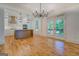 Open-concept living area with hardwood floors and access to balcony and kitchen at 5106 N Pratt St, Covington, GA 30014