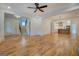 Bright, open-concept living area features hardwood floors, ceiling fan, and seamless transition to kitchen at 5106 N Pratt St, Covington, GA 30014
