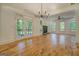 Spacious living area with fireplace, views of the outdoor greenery, and hardwood floors at 5106 N Pratt St, Covington, GA 30014
