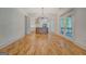 Open-concept living area with hardwood floors, access to balcony, and views into the kitchen at 5106 N Pratt St, Covington, GA 30014