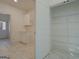 Mudroom with cabinets, shelving, and tile floors leads to a walk-in pantry with shelving at 5106 N Pratt St, Covington, GA 30014