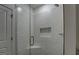 Shower features a glass door, white tile surround, chrome hardware and a built-in niche at 5106 N Pratt St, Covington, GA 30014