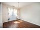 Dining area featuring hardwood floors, double doors, and a decorative light fixture at 6517 Snowbird Ln, Douglasville, GA 30134