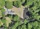 Aerial perspective of the property showcasing the home, pond, and wooded surroundings at 701 Mask Rd, Brooks, GA 30205