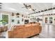 Bright living room featuring a stone fireplace, beamed ceilings, and access to the patio through French doors at 701 Mask Rd, Brooks, GA 30205