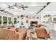 Spacious living room with a stone fireplace, beamed ceilings, lots of seating and views to the kitchen at 701 Mask Rd, Brooks, GA 30205