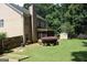 Well maintained fenced backyard with a brick home, a screened porch, mature trees, and a storage shed at 305 Matthew Cir, Stockbridge, GA 30252