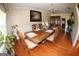 Dining room showcases a decorative table, hardwood floors, and a large window at 305 Matthew Cir, Stockbridge, GA 30252