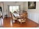 Bright dining area showcases a decorative table, hardwood floors, and a large window at 305 Matthew Cir, Stockbridge, GA 30252