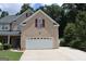 Attractive brick home with attached two-car garage at 305 Matthew Cir, Stockbridge, GA 30252