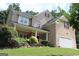Attractive two-story brick home with a well-kept lawn and an attached two-car garage at 305 Matthew Cir, Stockbridge, GA 30252