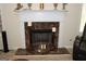 Close-up of the fireplace, decorated with marble and matching decor at 305 Matthew Cir, Stockbridge, GA 30252