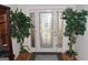Elegant front entryway featuring hardwood floors, decorative glass door and lush greenery at 305 Matthew Cir, Stockbridge, GA 30252