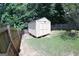 A storage shed in a fenced backyard provides ample space for all your lawn and garden equipment at 305 Matthew Cir, Stockbridge, GA 30252