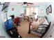 Bright bedroom with light blue walls, ceiling fan, embroidery machine, and comfortable queen size bed at 305 Matthew Cir, Stockbridge, GA 30281