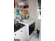 Convenient laundry room features a washer, dryer, and ample storage space at 305 Matthew Cir, Stockbridge, GA 30281