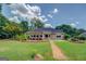 Charming backyard featuring a well-maintained lawn and attractive landscaping around the home's exterior at 1615 Clairmont Sw Ln, Conyers, GA 30094