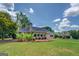 Expansive backyard featuring a meticulously maintained lawn and established greenery around the house at 1615 Clairmont Sw Ln, Conyers, GA 30094