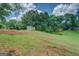 A secluded backyard setting with a storage shed and a gentle slope, perfect for outdoor projects at 1615 Clairmont Sw Ln, Conyers, GA 30094