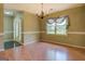 Open-concept layout showing a dining area adjacent to the foyer with view of the front yard through a bright window at 1615 Clairmont Sw Ln, Conyers, GA 30094