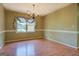 Bright dining area with chandelier, large window with decorative curtains, and wood-look flooring at 1615 Clairmont Sw Ln, Conyers, GA 30094