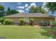 Side view of the home showing well-maintained siding, lush landscaping, and a neatly trimmed lawn at 1615 Clairmont Sw Ln, Conyers, GA 30094