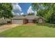 Inviting home with well-maintained lawn, neutral exterior, and attached two-car garage on a sunny day at 1615 Clairmont Sw Ln, Conyers, GA 30094
