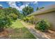 Garage with white door, stone edging, and landscaped area, offering curb appeal and functionality at 1615 Clairmont Sw Ln, Conyers, GA 30094