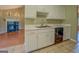 Classic kitchen features white cabinets, marble countertops, stainless sink, and black dishwasher at 1615 Clairmont Sw Ln, Conyers, GA 30094