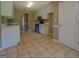 A kitchen with white cabinets and tile flooring at 1615 Clairmont Sw Ln, Conyers, GA 30094