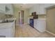 Kitchen featuring tile flooring, white cabinets, and modern appliances at 1615 Clairmont Sw Ln, Conyers, GA 30094