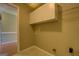 Laundry Room with built-in cabinets and tiled floor at 1615 Clairmont Sw Ln, Conyers, GA 30094