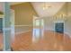 Large living room featuring a vaulted ceiling, fireplace, and seamless flooring leading to other areas of the home at 1615 Clairmont Sw Ln, Conyers, GA 30094