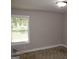 Bedroom features a neutral color scheme with carpeting and a double-hung window at 1627 Orlando Sw St, Atlanta, GA 30311