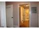 Hallway with multiple doors, one leading to a full bathroom with tub at 1627 Orlando Sw St, Atlanta, GA 30311