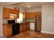 Classic kitchen featuring wood cabinets, stainless steel refrigerator and black stove at 1627 Orlando Sw St, Atlanta, GA 30311